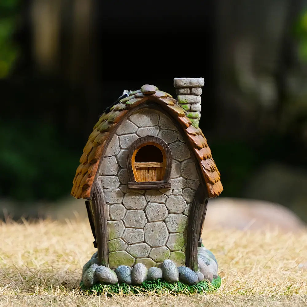 Solar fairy garden cottage back view showing stone texture round window and chimney