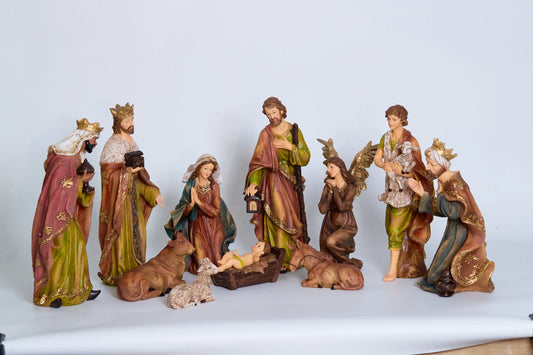 All 11 nativity figurines on white background including Holy Family, Magi, shepherd, kneeling angel, and stable animals