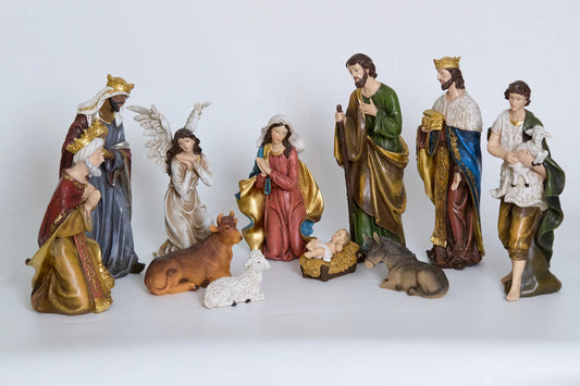 Complete 11-piece nativity scene set on white background — hand-painted resin Holy Family, Three Kings, angel, shepherd, and animals