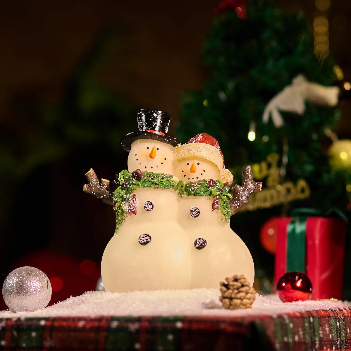  Lighted snowman couple figurine close-up — warm amber LED resin Christmas snowman decoration