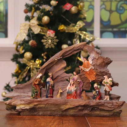 Lighted Christmas nativity scene with Holy Family figurines inside rustic cave manger decoration