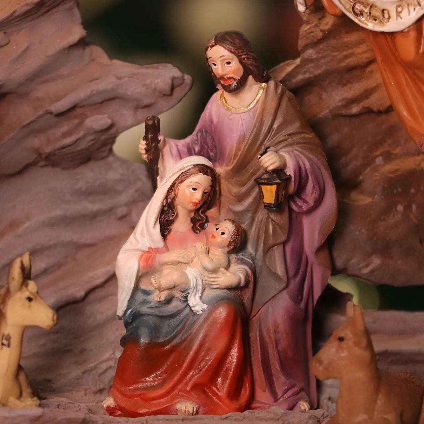 Close-up view of Baby Jesus Mary and Joseph nativity figurines in Christmas manger scene