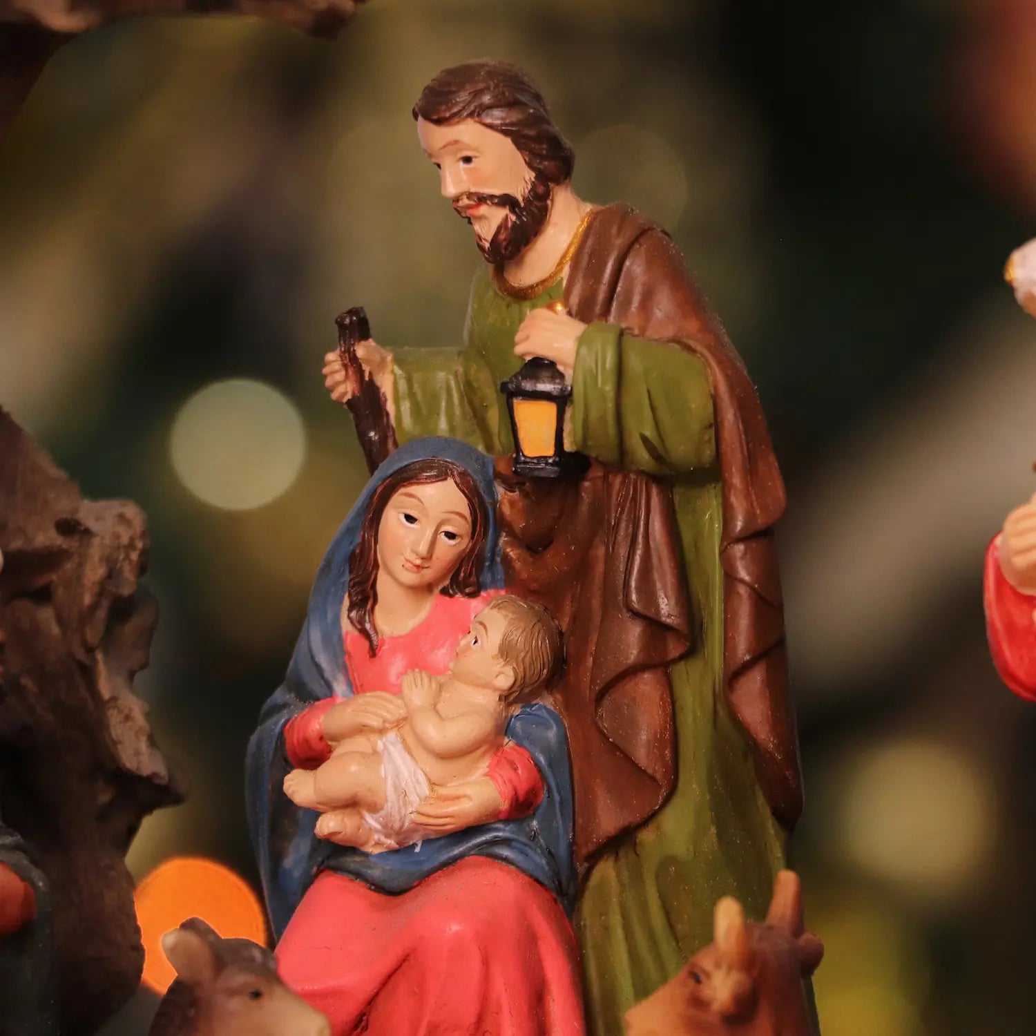 Close-up view of Mary, Baby Jesus, and Joseph figurines in LED Christmas nativity scene