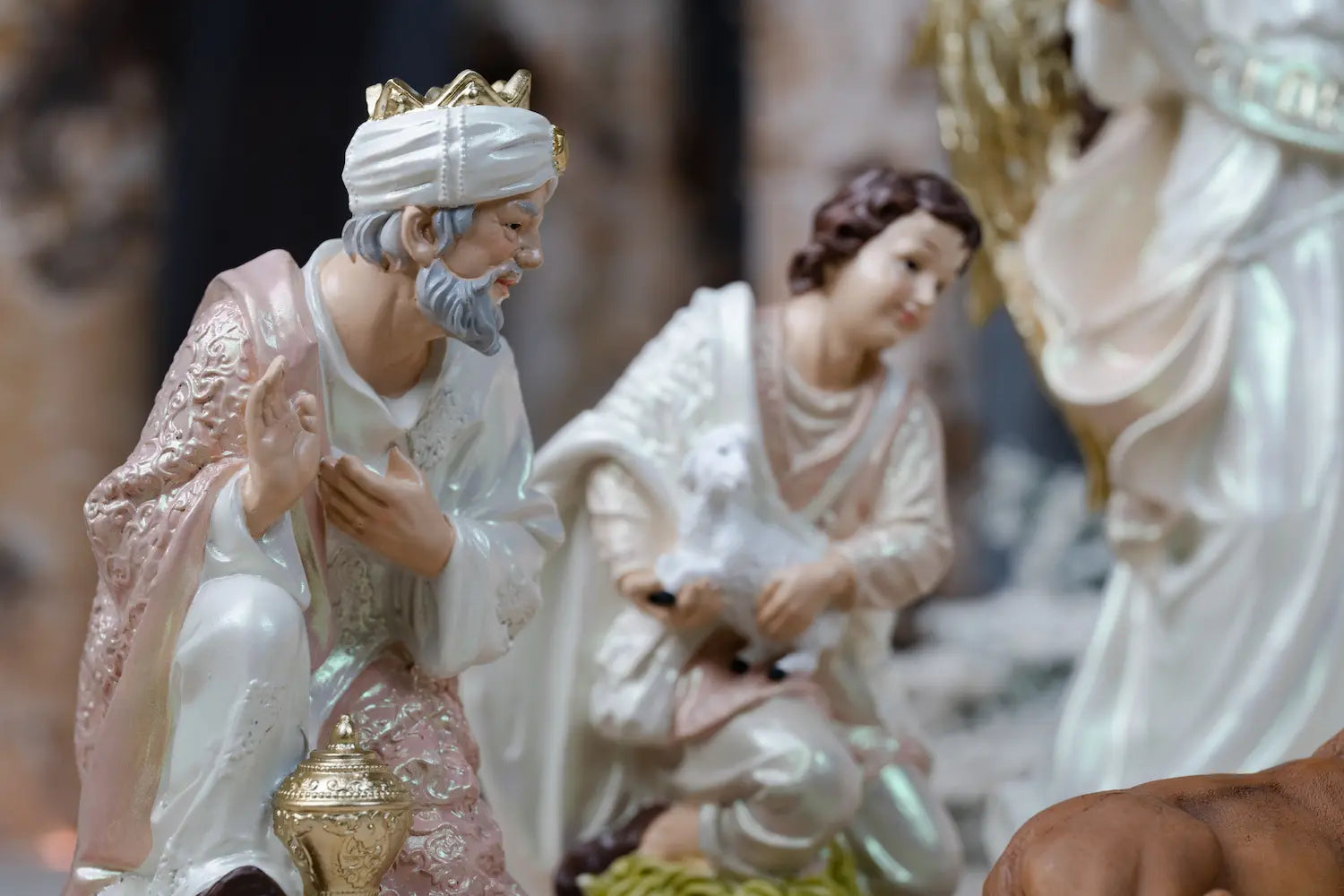 wise man and shepherd carrying lamb nativity figurines