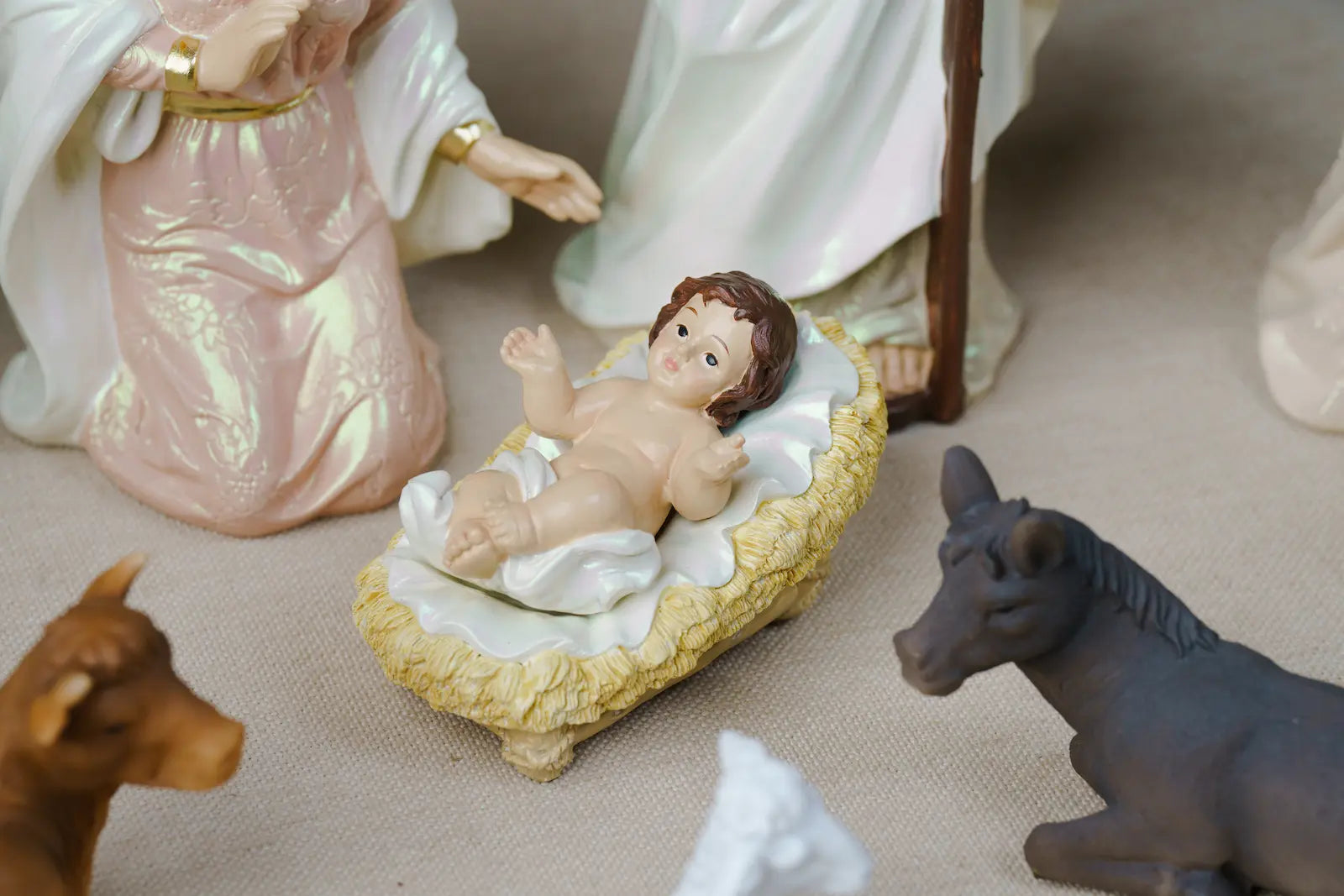 baby jesus in straw manger nativity scene detail