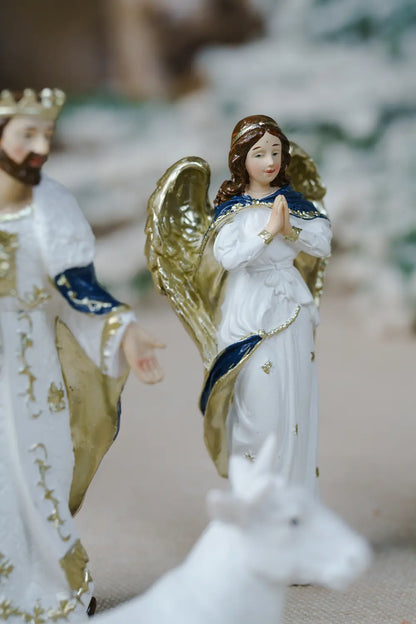 white angel figurine with gold wings and blue trim.