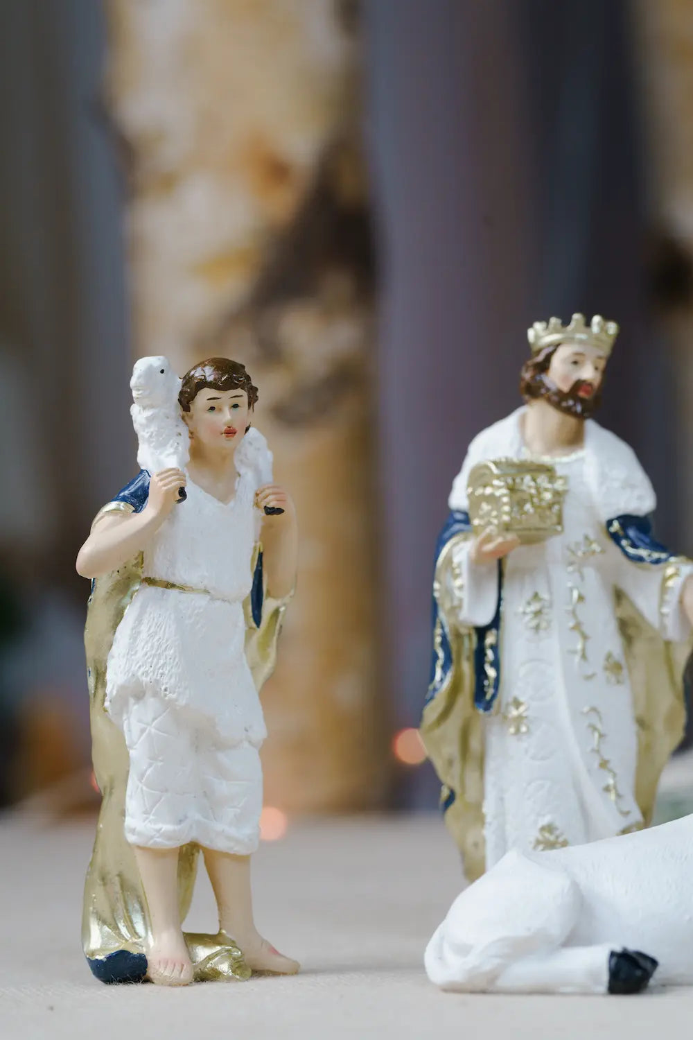 shepherd carrying lamb shoulders blue white nativity figurine