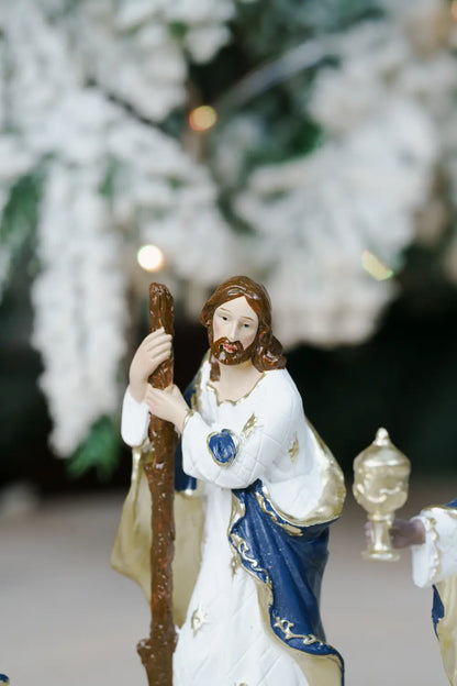 A religious figurine of Jesus holding a wooden staff.
