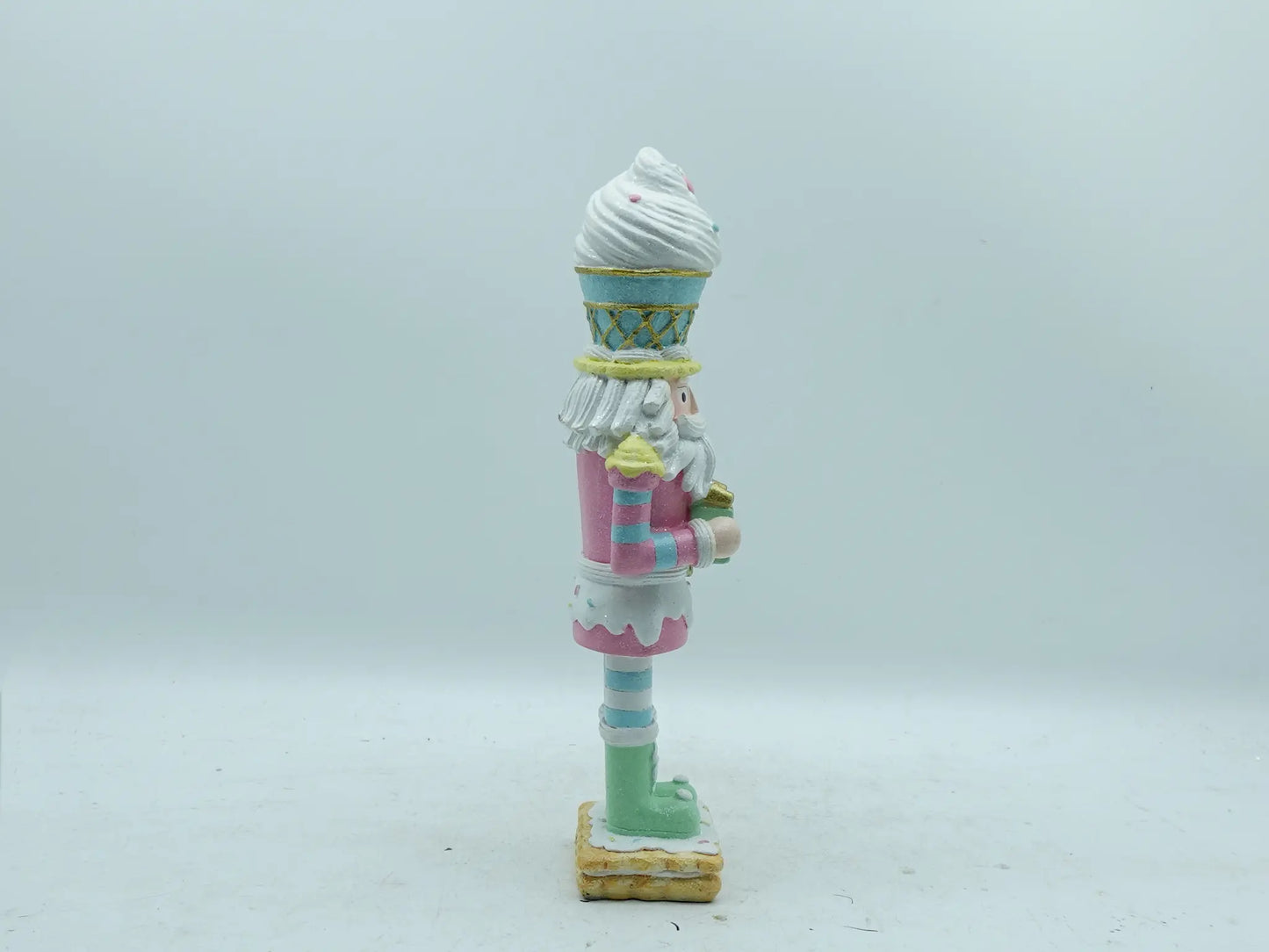 Right side view of the hand-painted resin nutcracker figurine with gift box