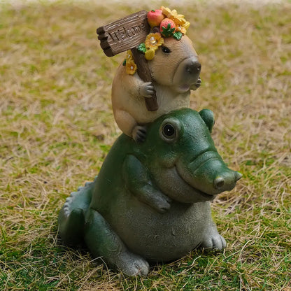 cute capybara alligator statue holding welcome sign
