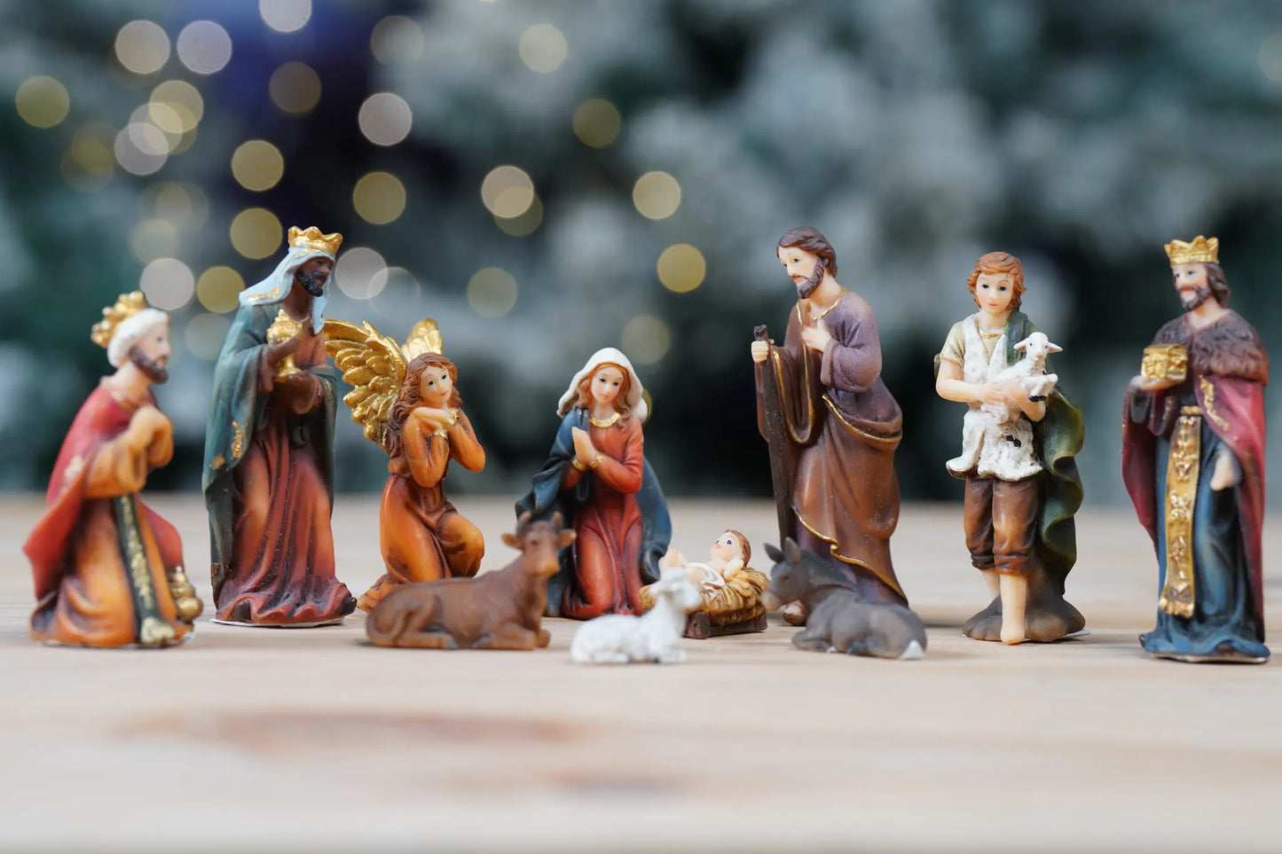Small Bethlehem scene figurines close-up, colorful Christian holiday decor.