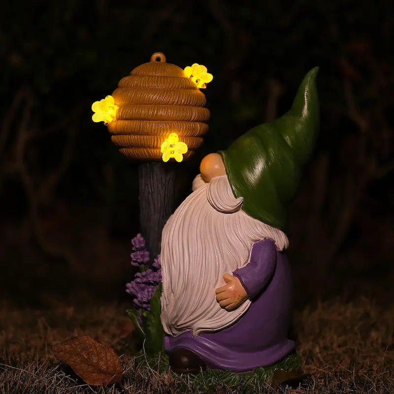 Gnome figurine with a beehive and flowers on a dark background