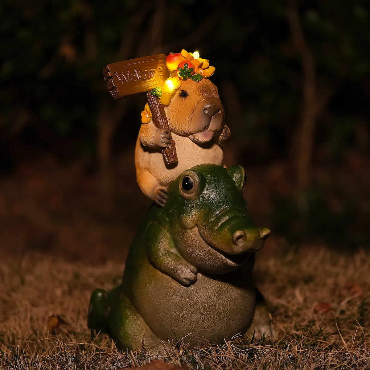 capybara riding alligator garden figurine glowing at night with LED lights in flower crown