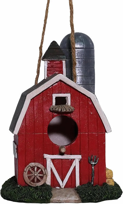 Resin red barn birdhouse with wagon wheel, pitchfork, and hay bales