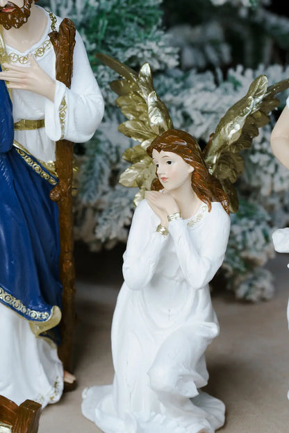 A white kneeling angel figurine with gold wings.
