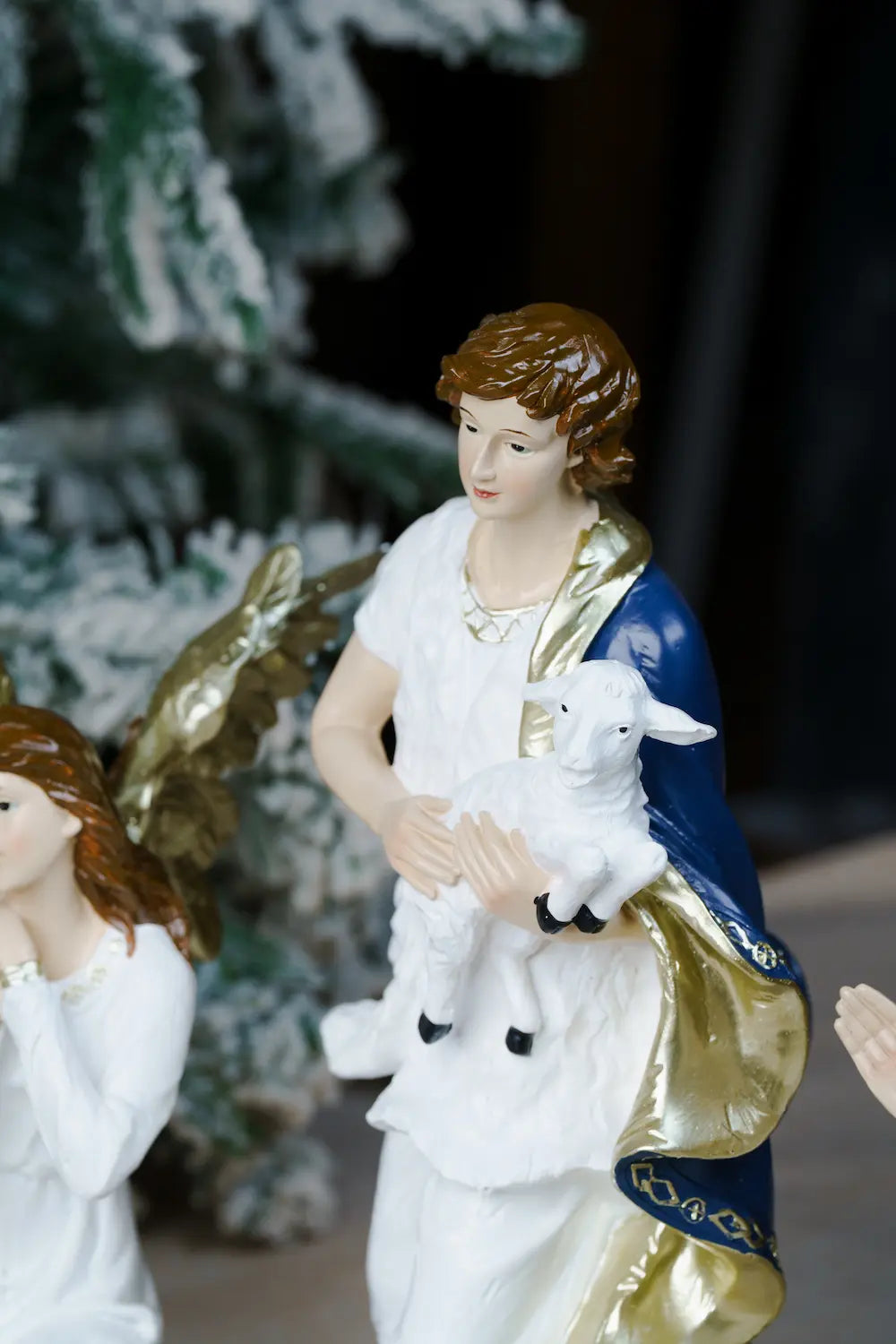 shepherd boy cradling lamb, nativity scene detail