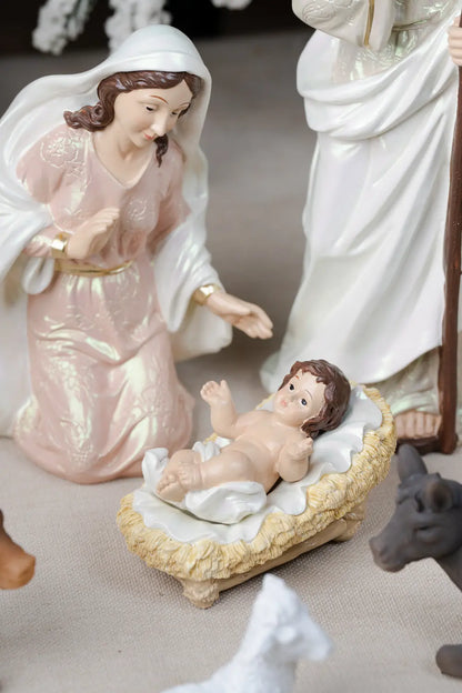 mary kneeling beside baby jesus in woven manger detail
