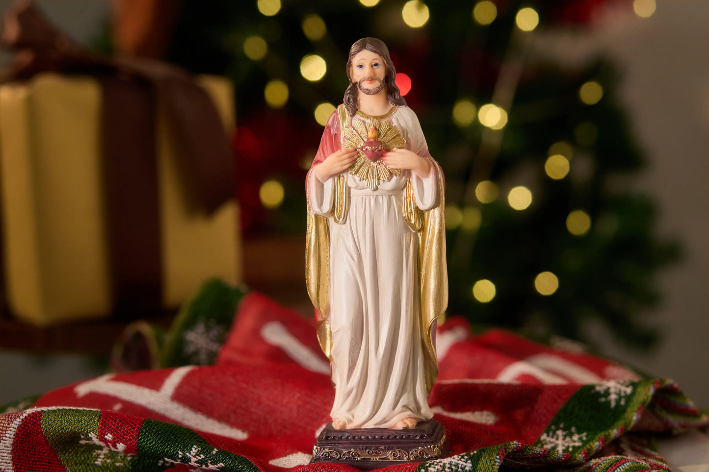 Sacred Heart of Jesus statue with Christmas decor in background