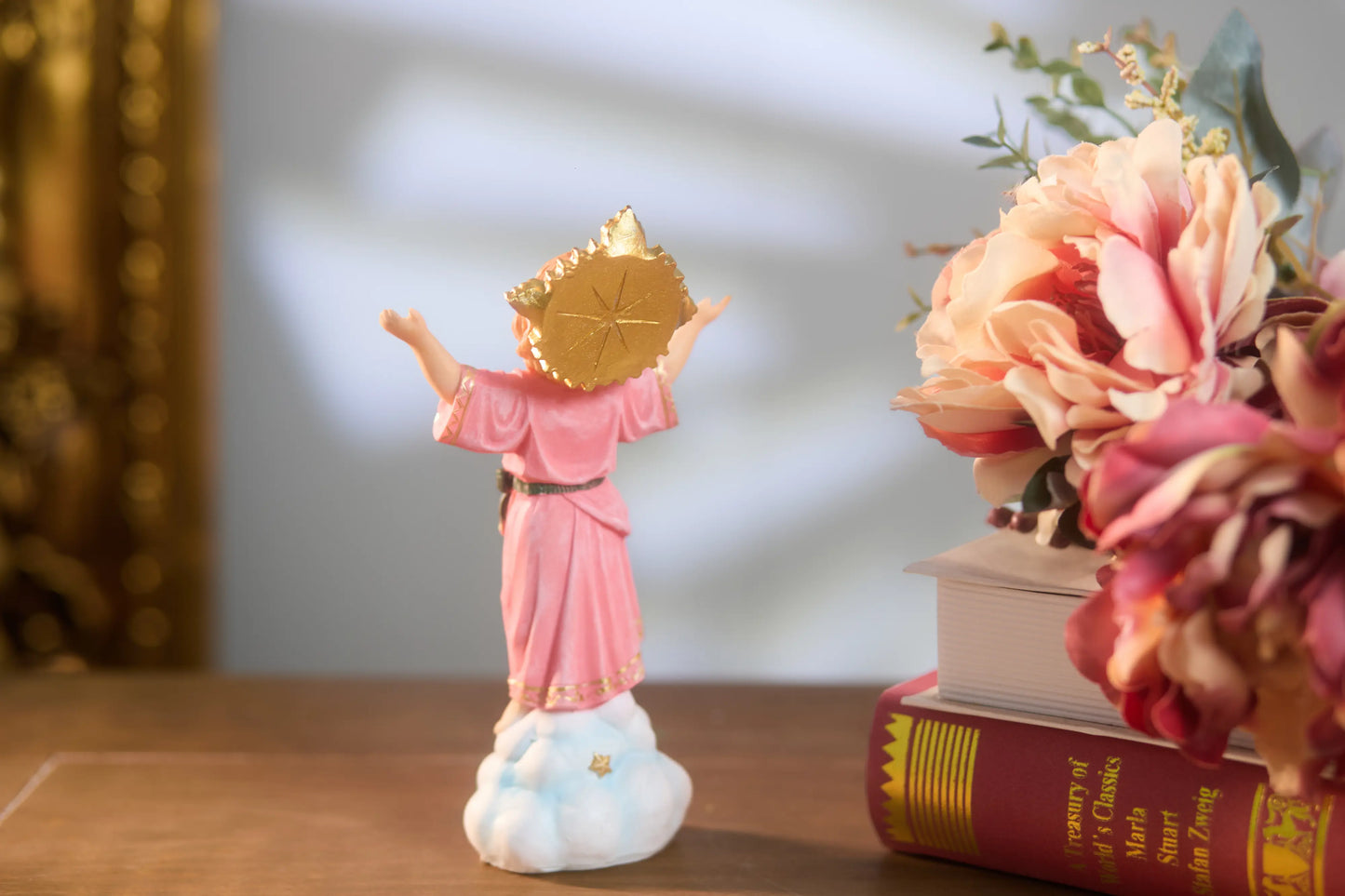 Divine Child resin statue rear view showing golden sunburst halo and pink robe details