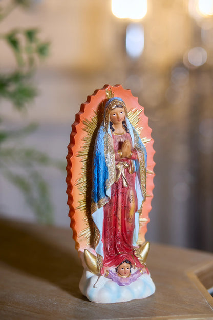 Our Lady of Guadalupe statue with angel cherub base on wooden table display