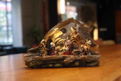 Traditional Christmas manger scene with warm lighting and detailed resin figures