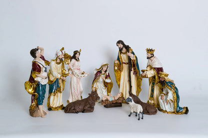 11 nativity figurines on white background including Holy Family, Magi, shepherd, Gloria angel, and stable animals