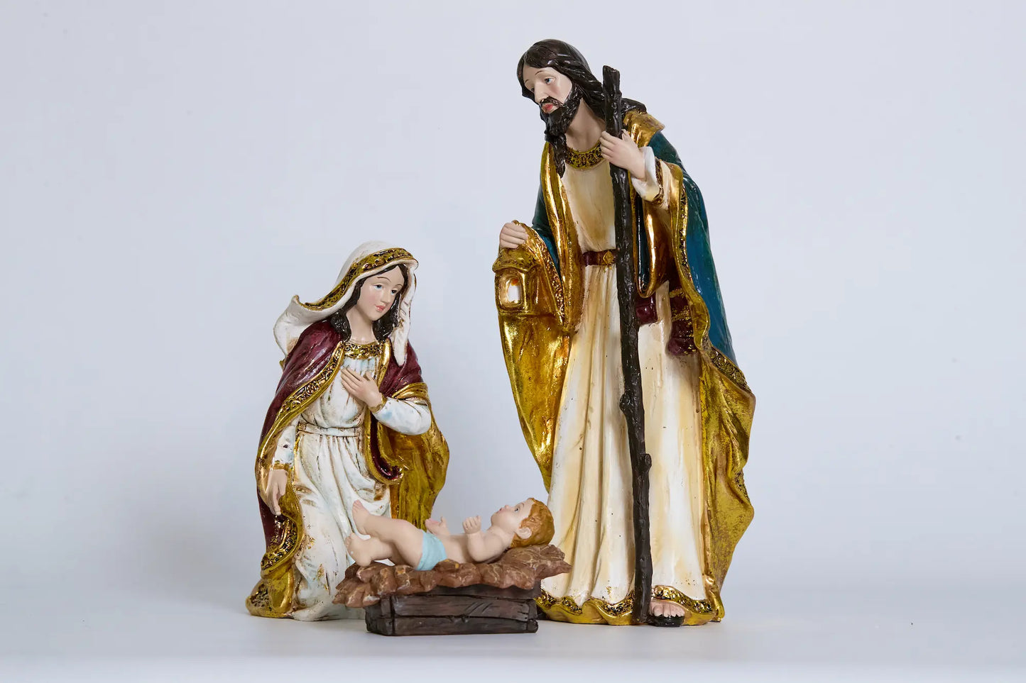 Holy Family close-up — Mary, Joseph with staff and lantern, and Baby Jesus in manger
