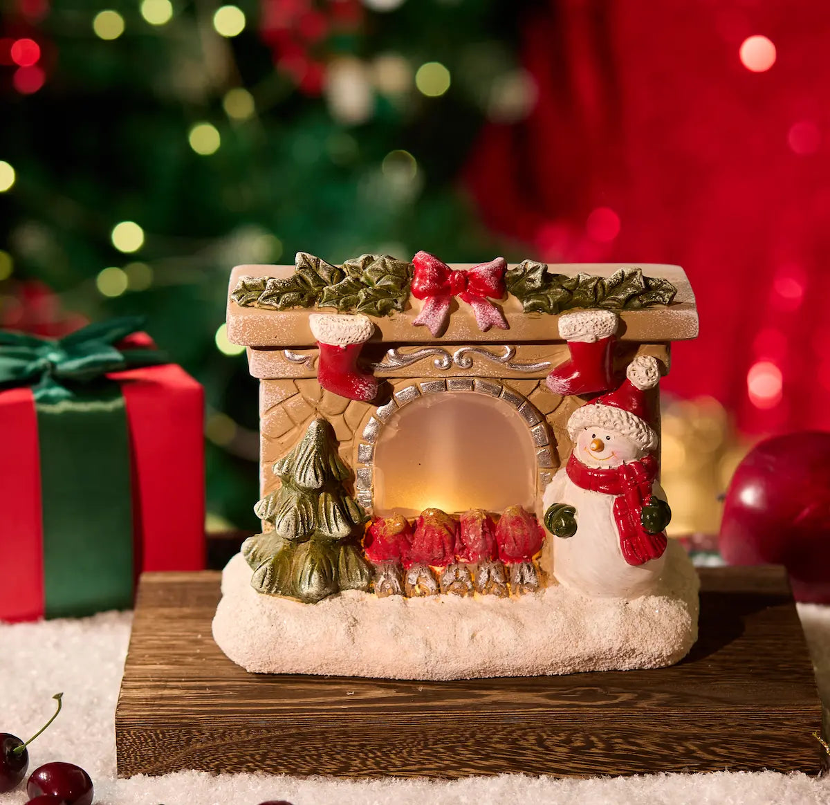 Hand-painted resin Christmas mantel decor with snowman and glowing fire close-up