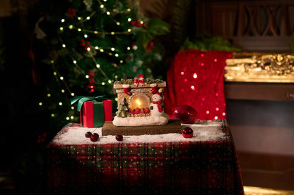 LED snowman fireplace decoration in cozy living room with Christmas tree background