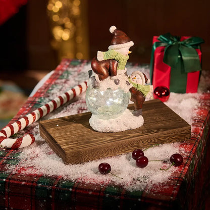 Lighted crackle-glass snowman figurine pair on wood block with candy canes and cherries — warm white LED Christmas tabletop decoration with holiday gift backdrop