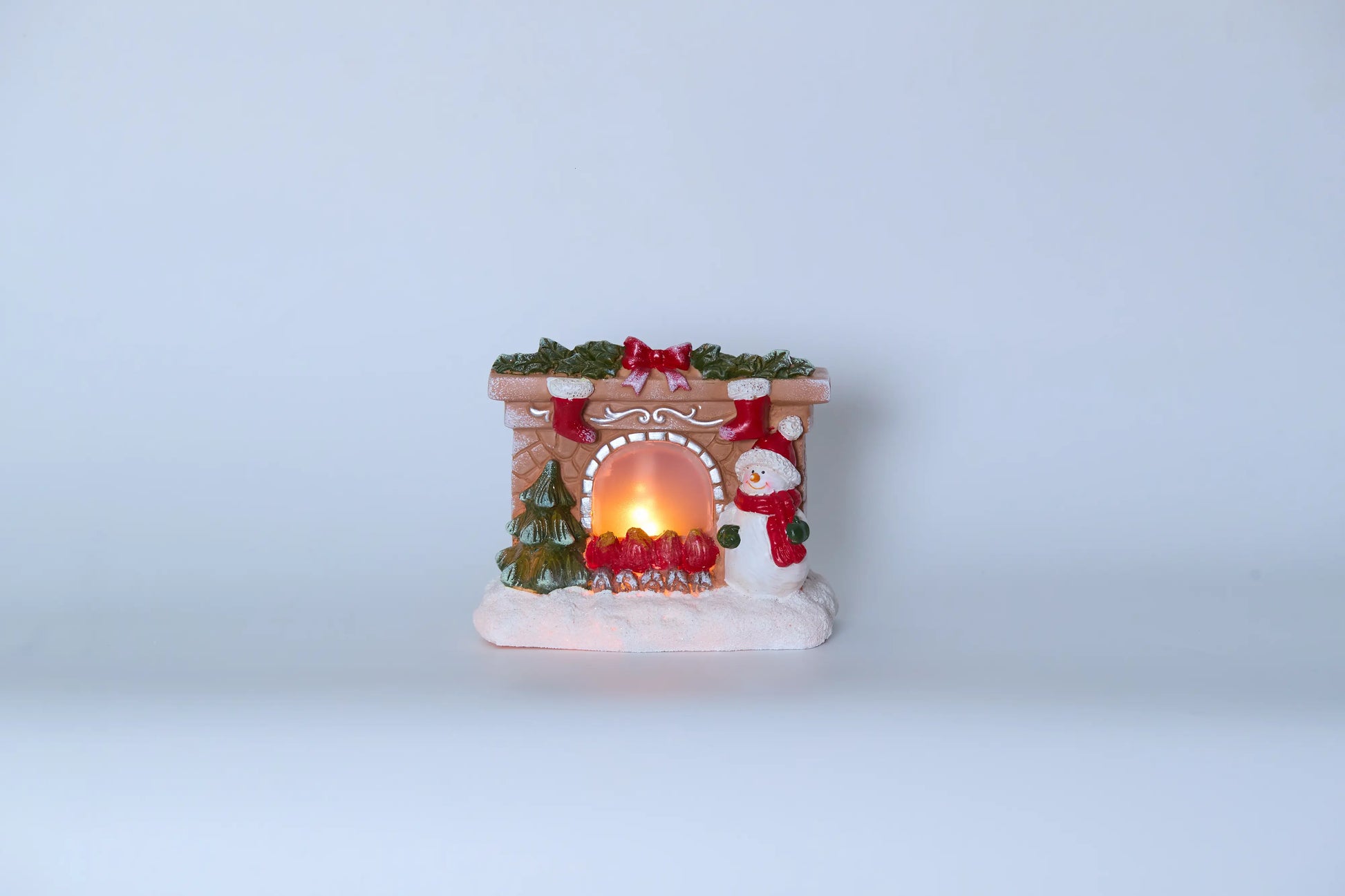 Snowman fireplace figurine front view on white background with warm LED light