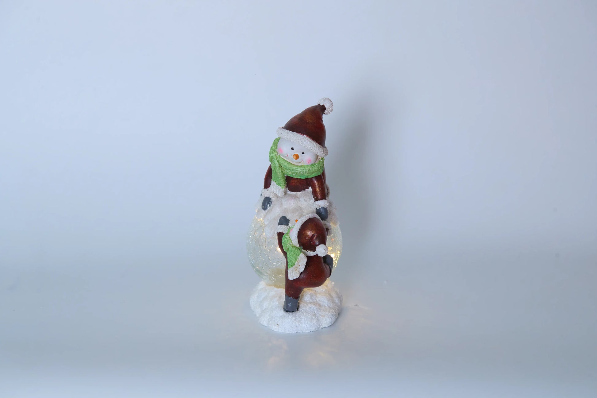 Zayton snowman duo figurine unlit front view — hand-painted resin snowmen with crackle-glass ball on white studio background