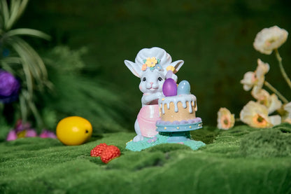 Easter bunny chef cake decoration on green moss with flowers