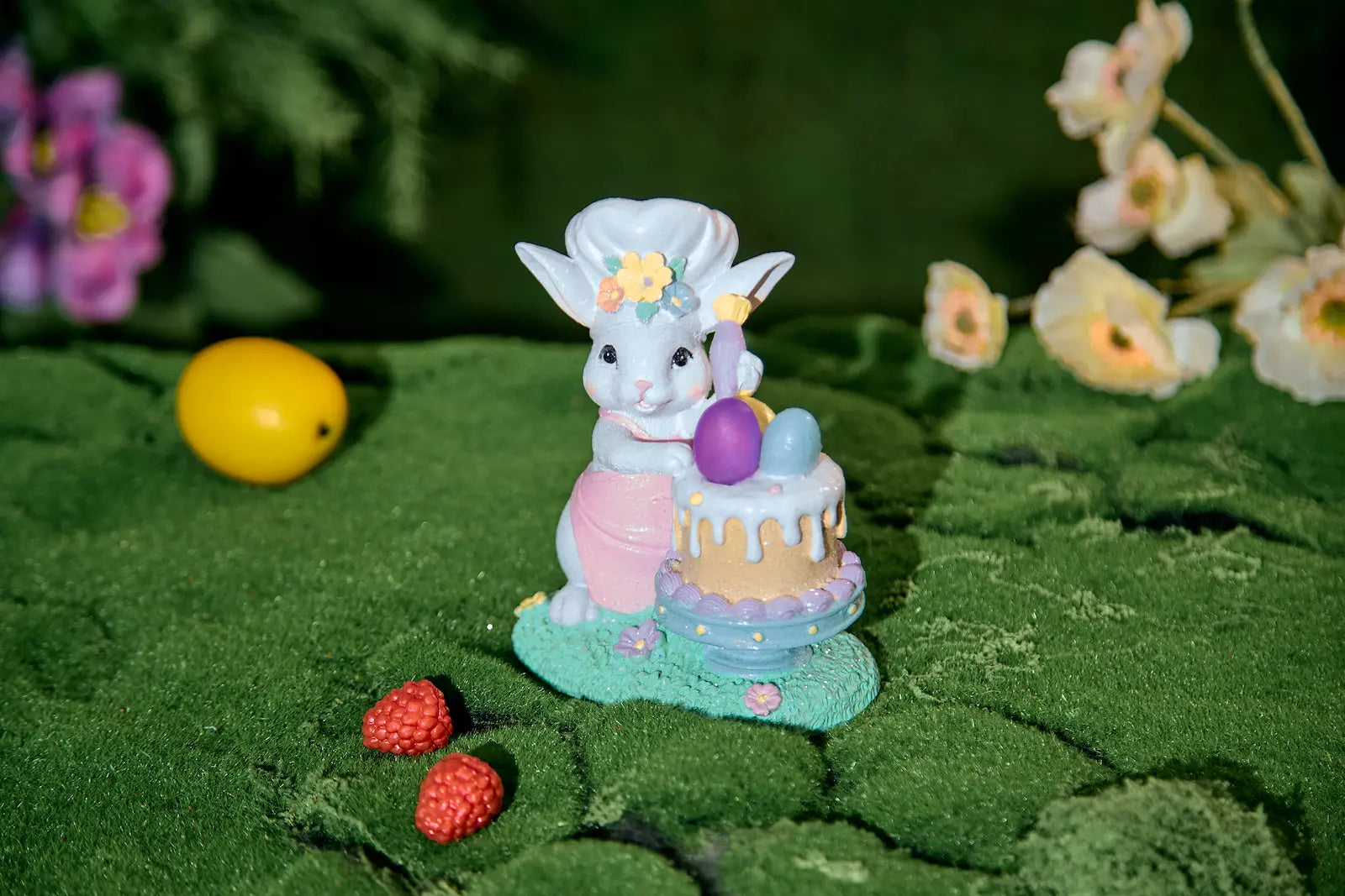 Light-up Easter bunny figurine with glowing pink egg in garden setting
