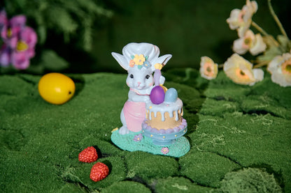 Light-up Easter bunny figurine with glowing pink egg in garden setting