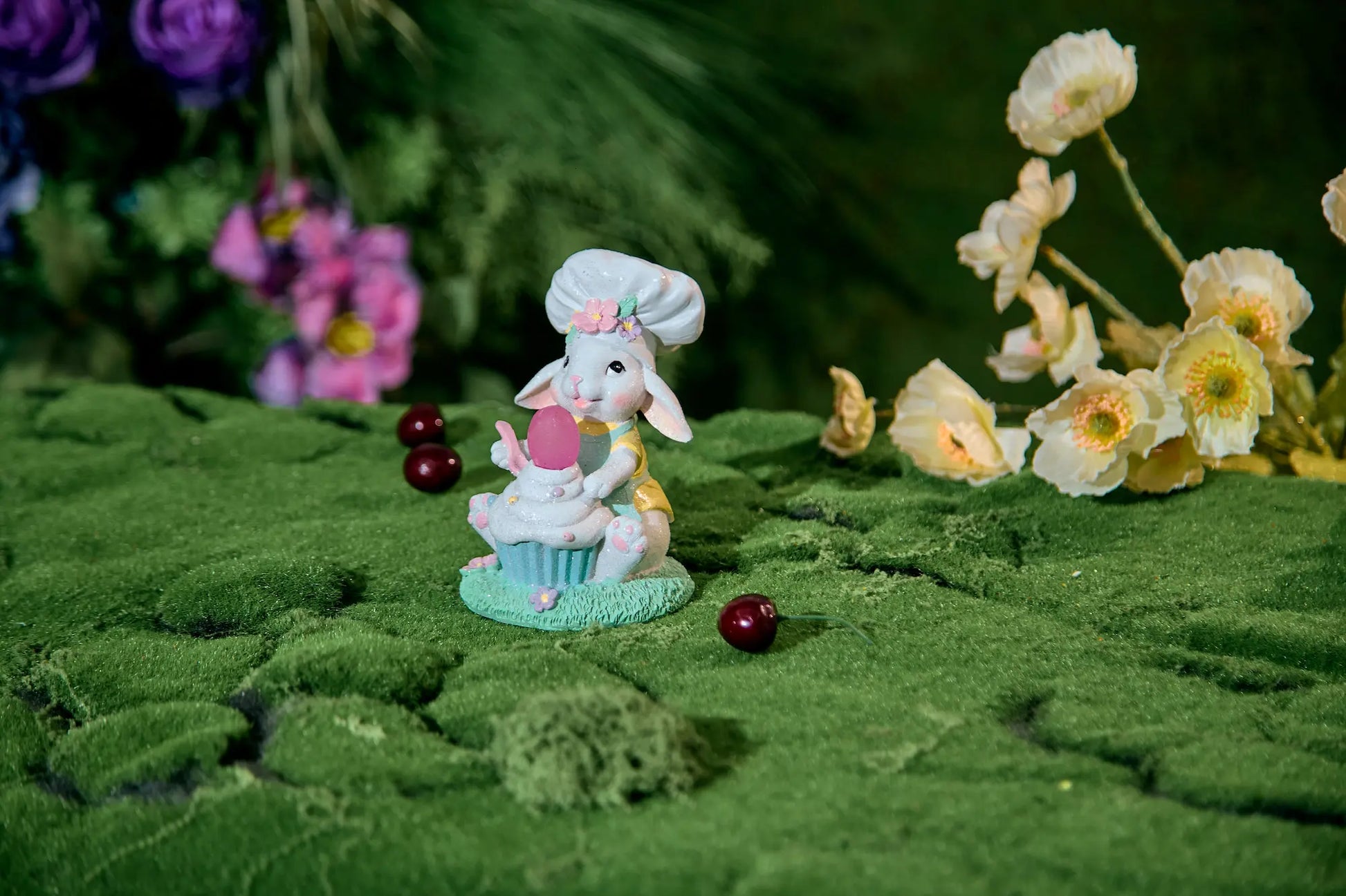 Easter bunny cupcake decor on green moss with spring flowers