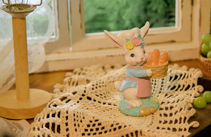 Pastel bunny baker figurine on tabletop with grapes and lamp