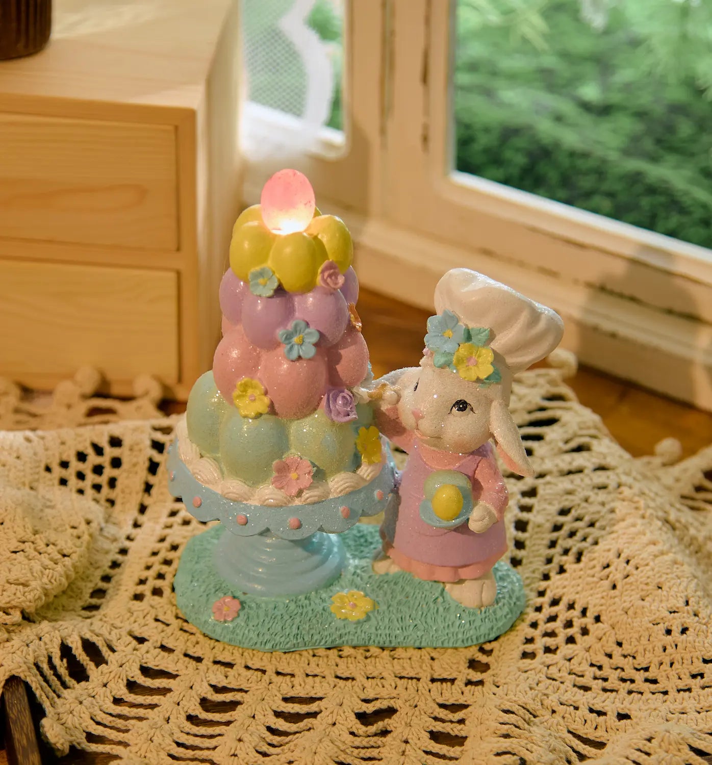  Easter bunny baker figurine with illuminated pink egg glowing on lace doily 