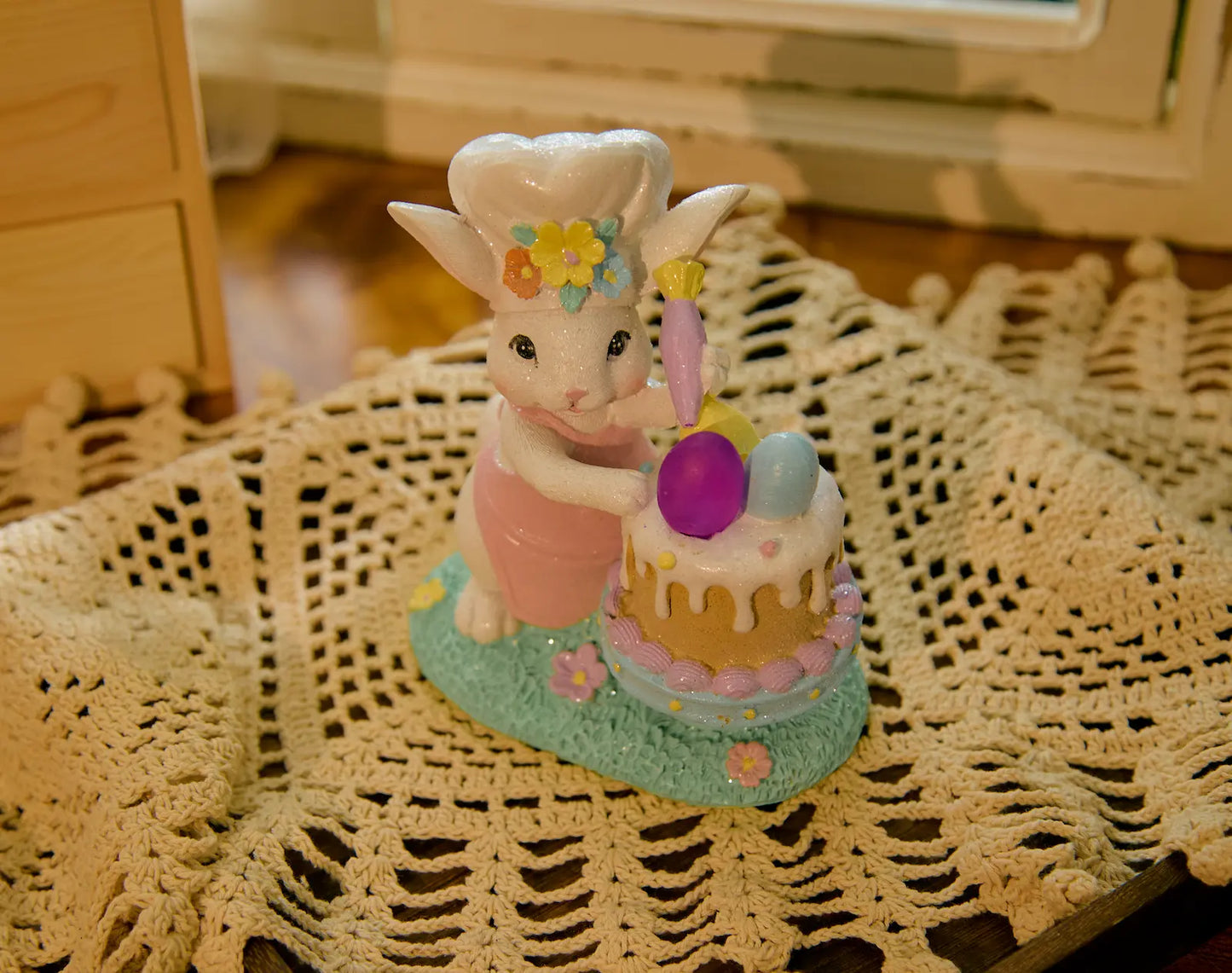 Close-up of hand-painted Easter bunny cake decoration indoors