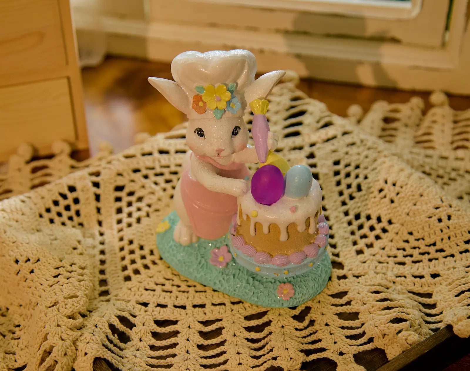 Close-up of hand-painted Easter bunny cake decoration indoors
