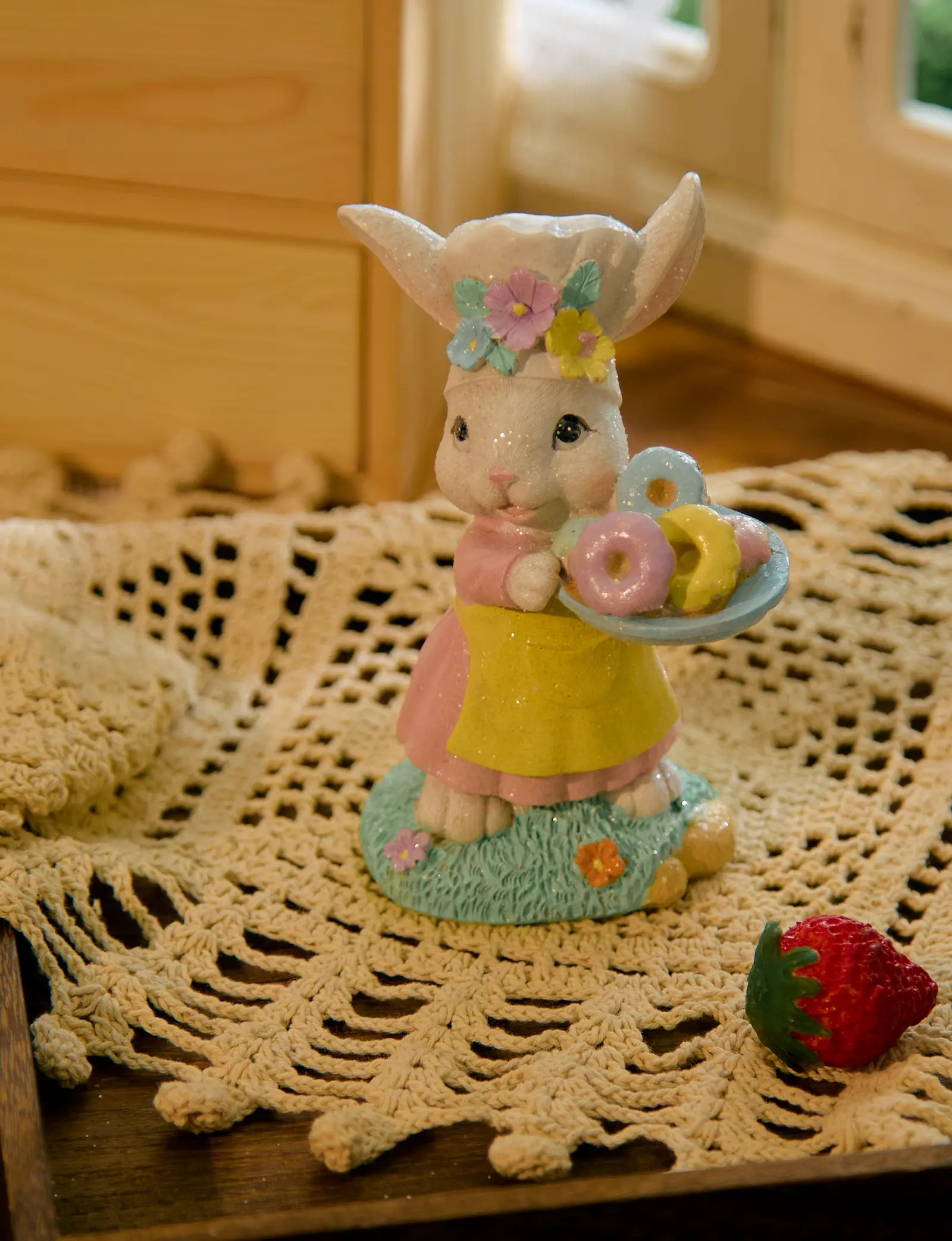 Easter bunny donut tray figurine on crochet doily with strawberry — pastel glitter resin spring shelf sitter in cottagecore home setting