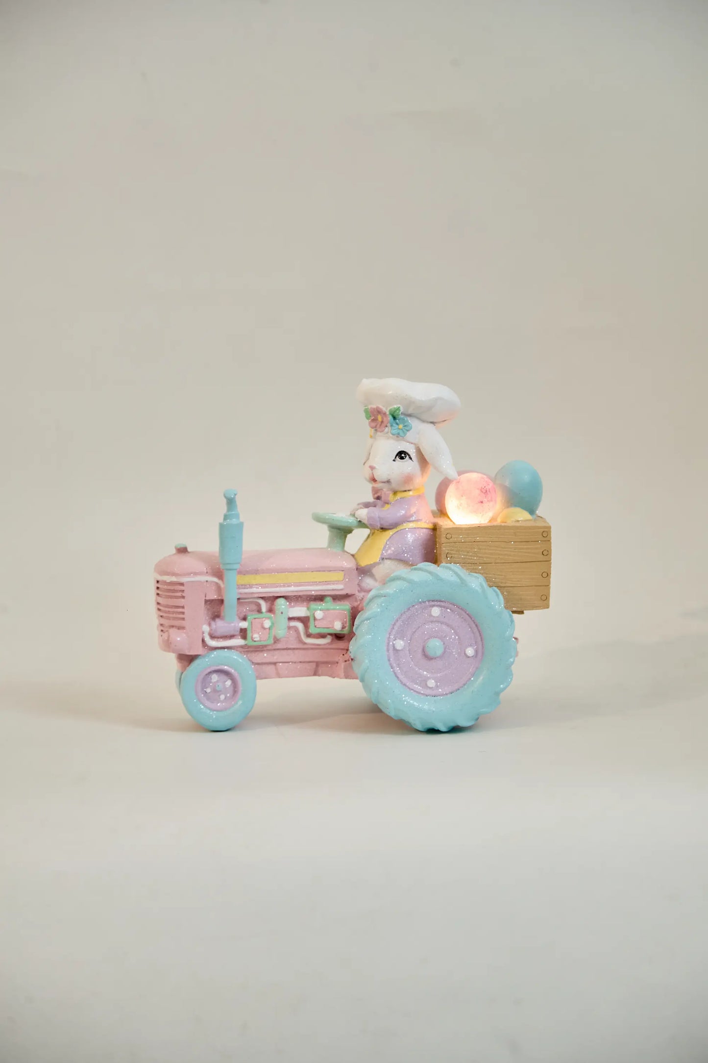 lighted Easter bunny tractor figurine with glowing egg crate — battery LED pastel resin spring decoration