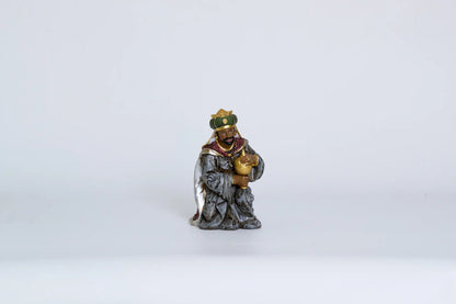Kneeling Wise Man figurine close-up, Magi figure for Christmas nativity decor.