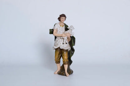 Nativity shepherd holding lamb close-up — hand-painted resin figurine detail