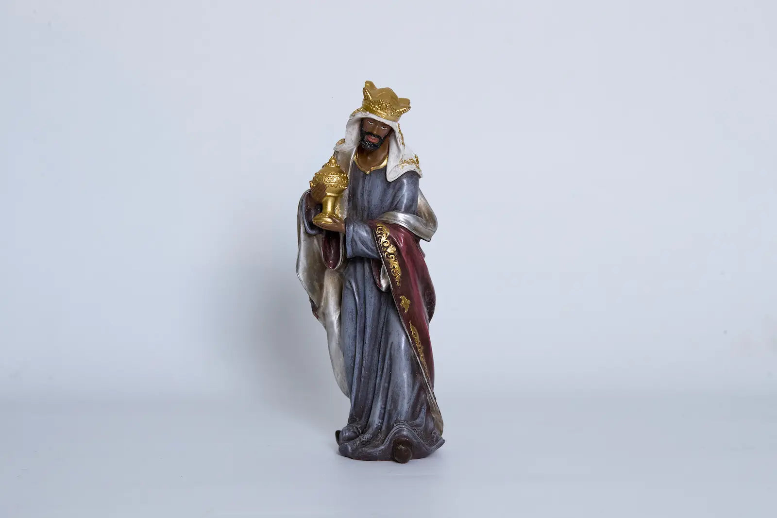 Nativity King Balthazar close-up — hand-painted resin Magi figurine holding gold gift vessel