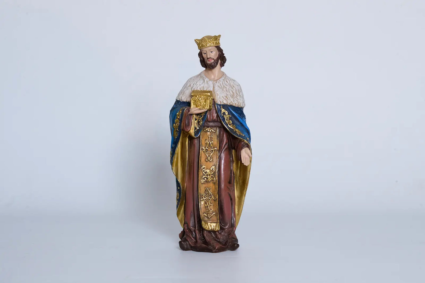 Nativity King Caspar close-up — hand-painted resin Magi figurine holding gold book
