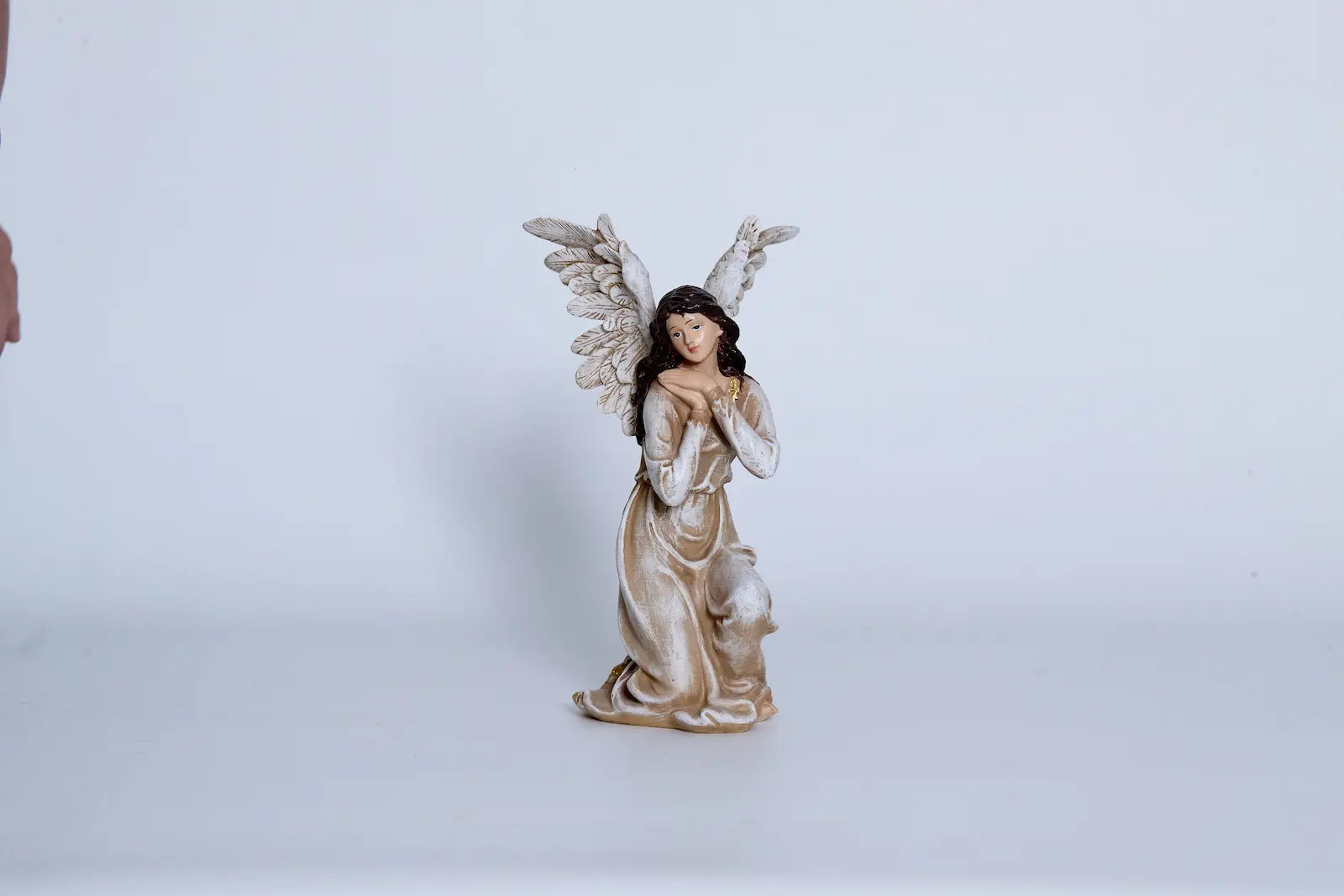Nativity angel close-up — hand-painted resin figurine with feathered wings