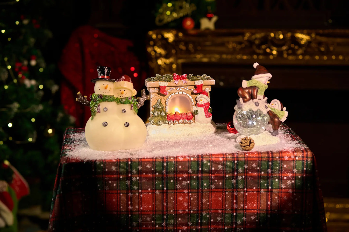 Full Christmas table vignette with glowing snowman couple, fireplace decoration, and crackle-glass snowman — lighted resin holiday mantel decoration display