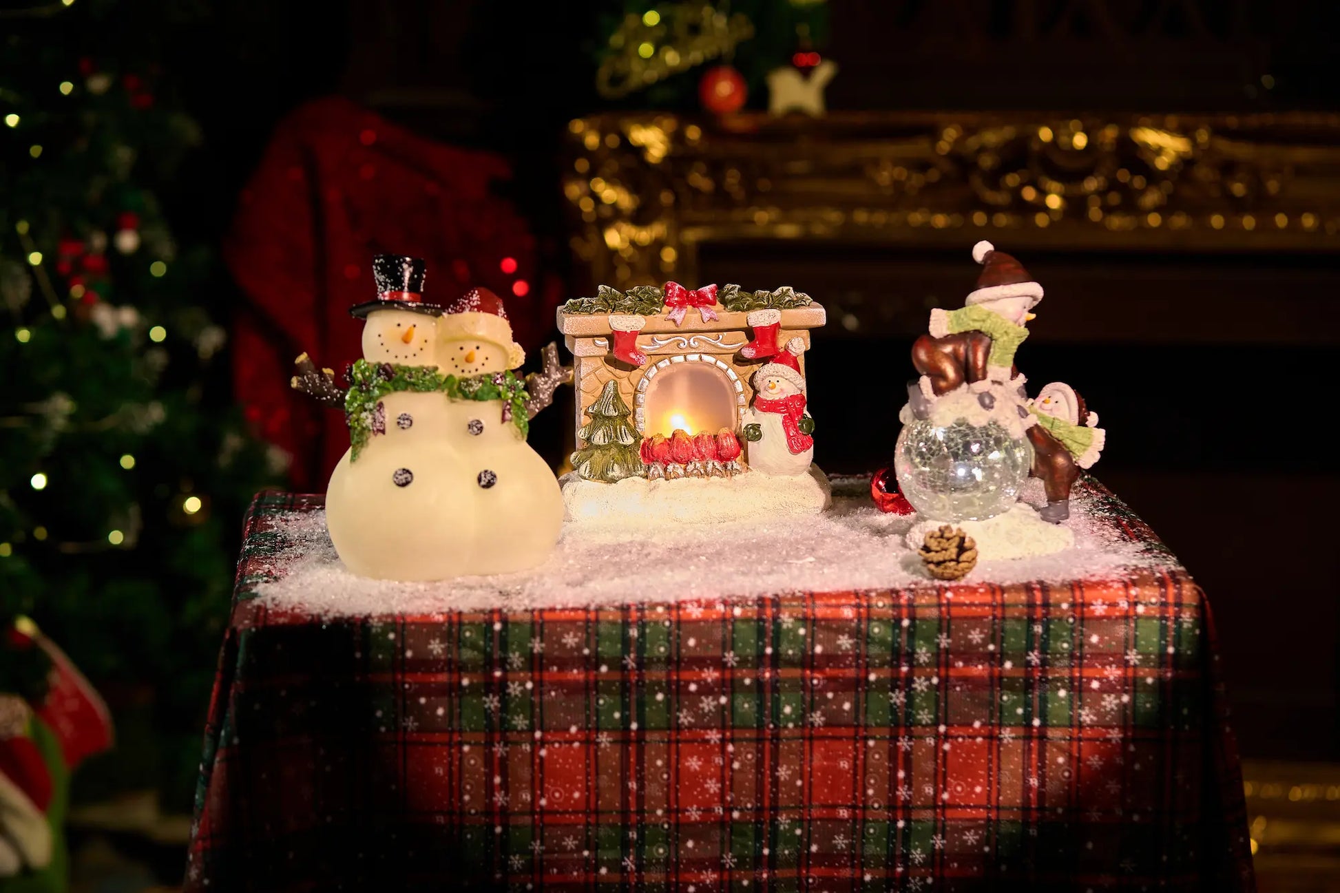 Full Christmas table vignette with glowing snowman couple, fireplace decoration, and crackle-glass snowman — lighted resin holiday mantel decoration display