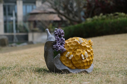Whimsical bee snail solar garden light decor displayed outdoors as yard accent